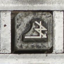 A metal punch with the symbol ⍼, mirrored