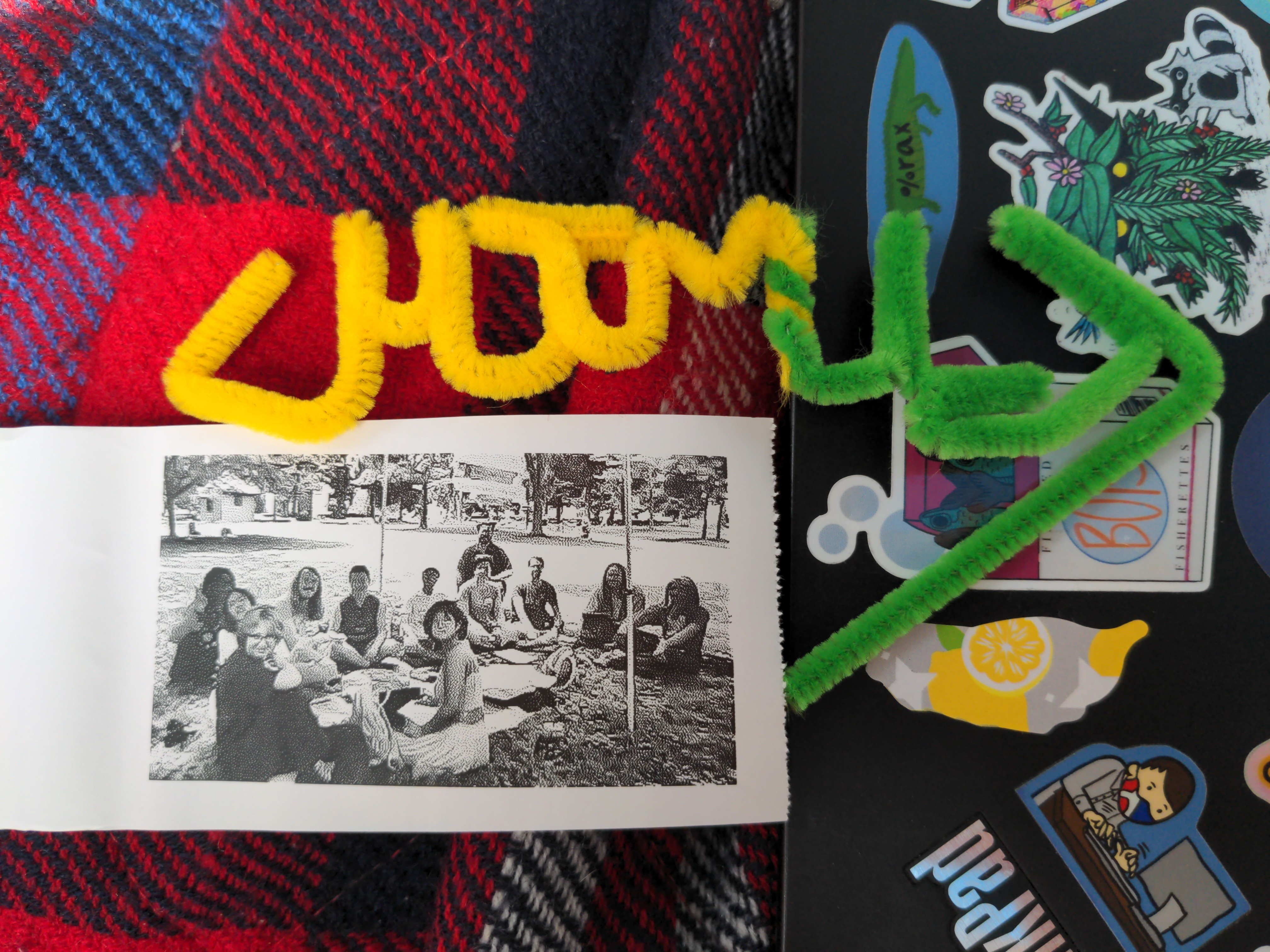 a thermal paper photo of a group of people and the <HTML> opening tag made out of pipe cleaners